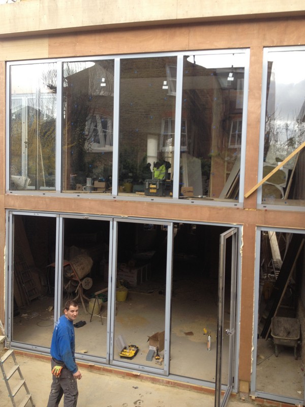 Aluminium bi-fold doors with two-storey glazing in Poplar