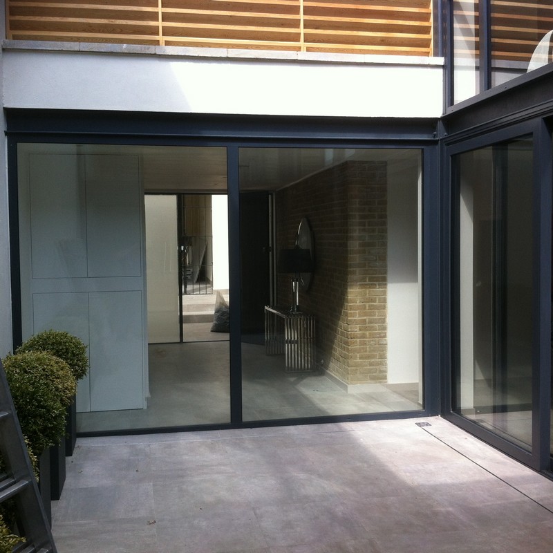 Floor-to-ceiling sliding doors opening to courtyard in Poplar