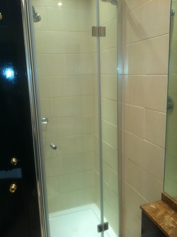 Frameless glass shower enclosure with chrome fittings in Poplar