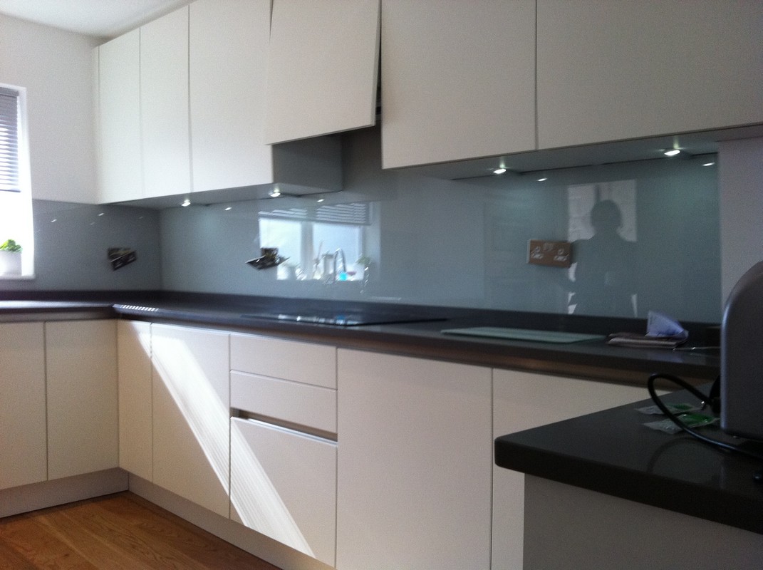 Grey glass kitchen splashback with LED lighting in Poplar