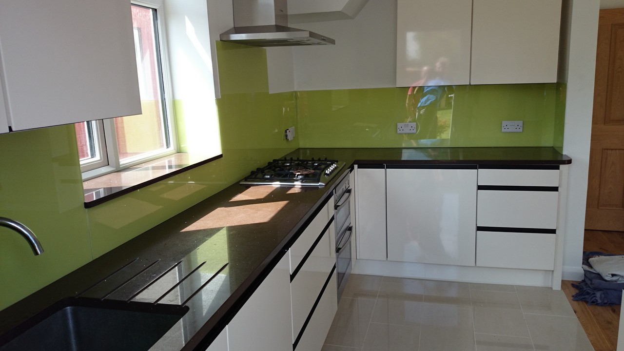 Lime green glass kitchen splashback installed by Poplar glaziers