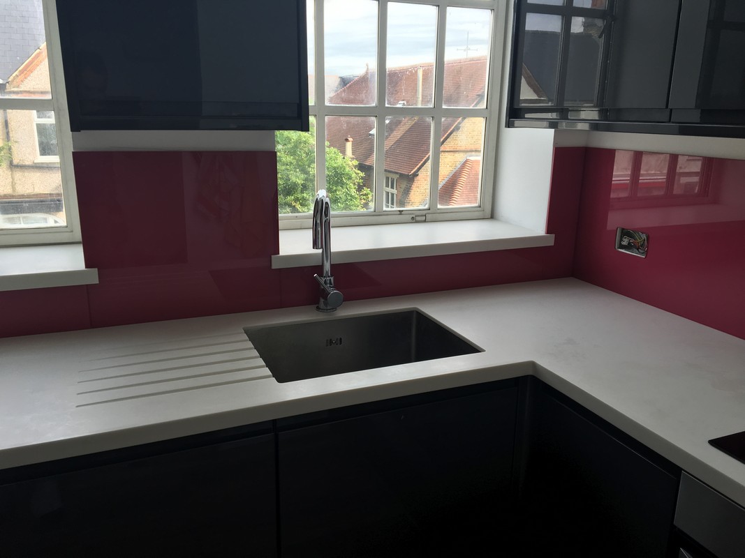 Deep plum coloured glass splashback in modern Poplar kitchen